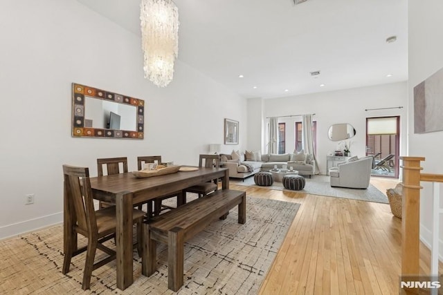 dining room featuring a notable chandelier, recessed lighting, baseboards, and wood-type flooring