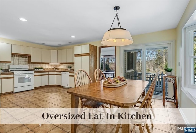 dining area featuring light tile patterned flooring and recessed lighting