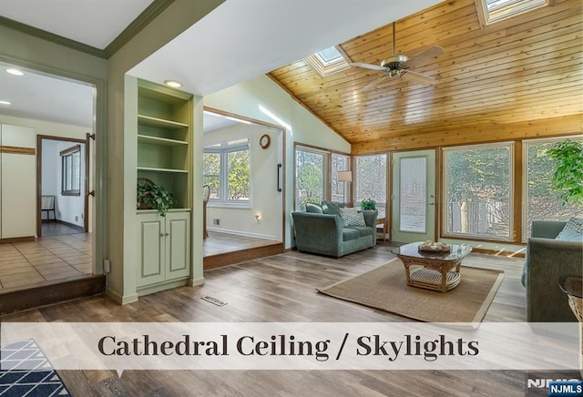 unfurnished living room with built in shelves, baseboards, lofted ceiling with skylight, wood ceiling, and wood finished floors