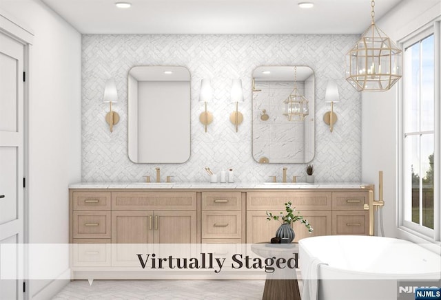 full bathroom featuring a sink, tasteful backsplash, a soaking tub, and double vanity