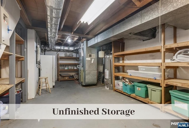 storage with gas water heater, visible vents, and heating unit