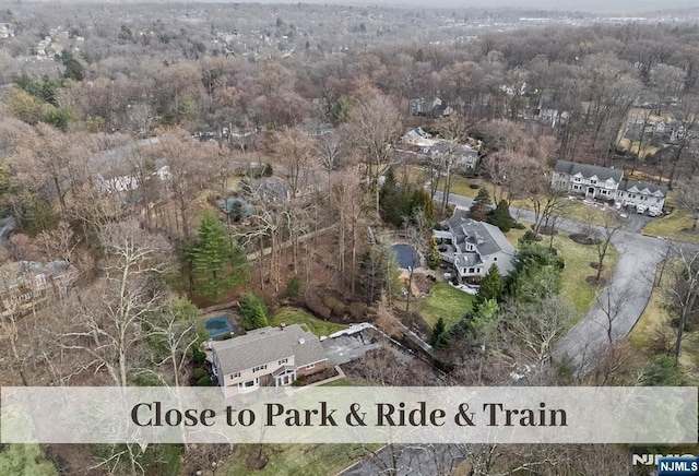 aerial view featuring a wooded view