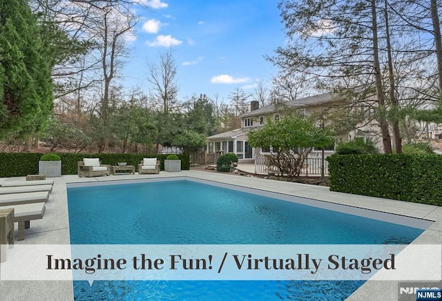 view of swimming pool with a fenced in pool, a patio, and fence