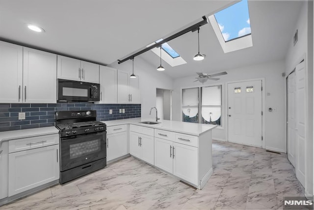 kitchen featuring a sink, marble finish floor, black appliances, and a peninsula