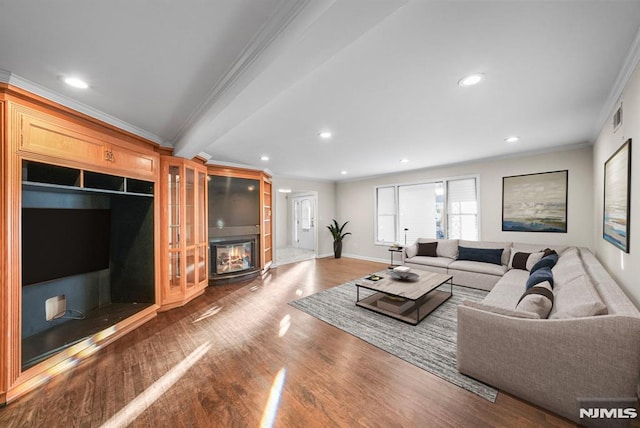 living area with wood finished floors, visible vents, recessed lighting, crown molding, and a large fireplace