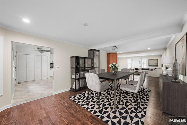 dining room featuring recessed lighting, baseboards, wood finished floors, and crown molding