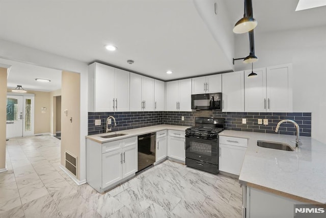 kitchen featuring visible vents, marble finish floor, black appliances, and a sink