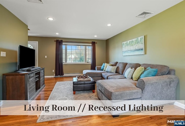 living room with wood finished floors, visible vents, baseboards, recessed lighting, and a baseboard heating unit