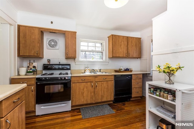 kitchen featuring brown cabinetry, a sink, light countertops, dishwasher, and range with gas cooktop