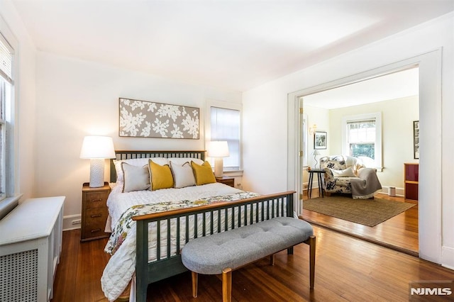 bedroom with baseboards and wood finished floors