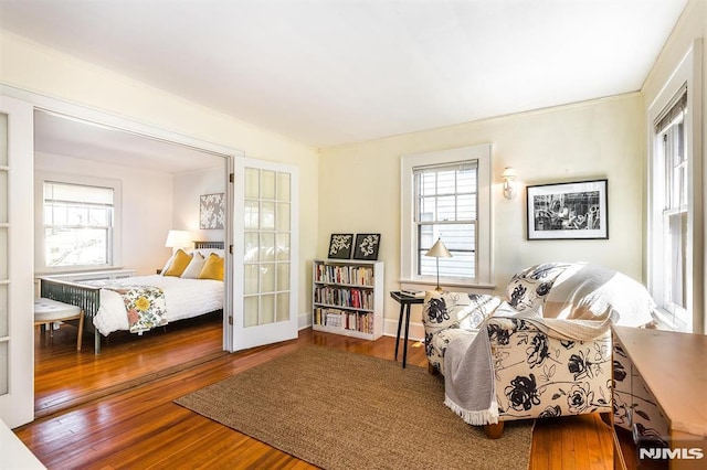 sitting room with french doors, baseboards, and hardwood / wood-style floors