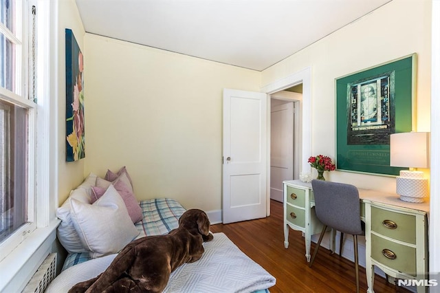 home office featuring wood finished floors and a baseboard radiator