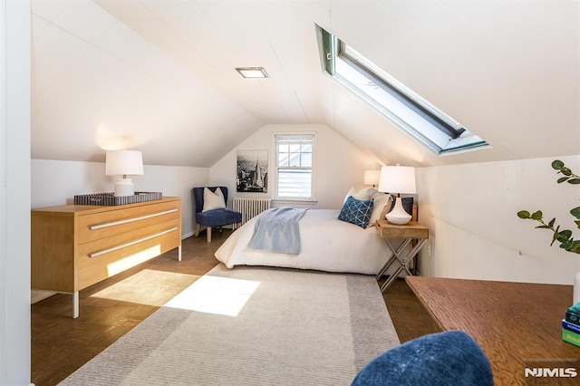 bedroom featuring vaulted ceiling with skylight