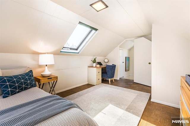 bedroom with baseboards and lofted ceiling