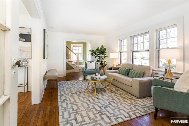 living area with stairway and hardwood / wood-style floors