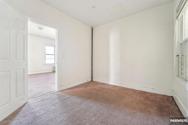 unfurnished room featuring baseboards and carpet floors