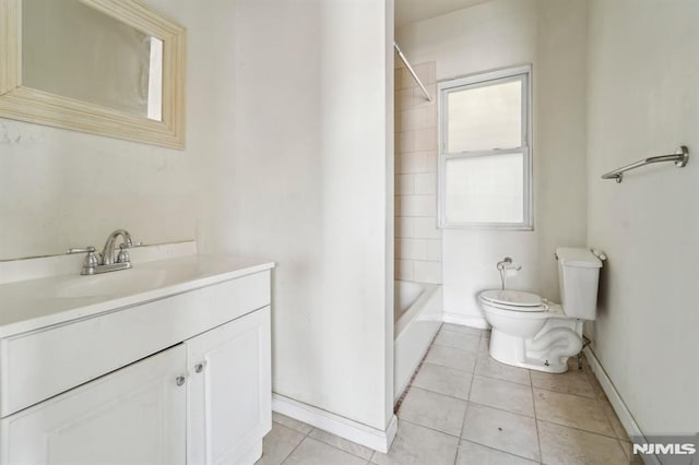 bathroom featuring tile patterned floors, baseboards, toilet, and vanity