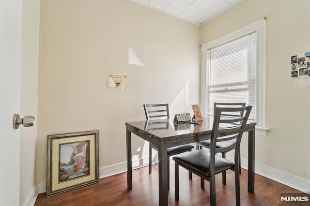 dining room with baseboards and dark wood-style flooring