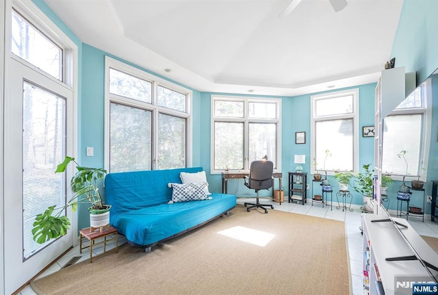 sunroom / solarium featuring a tray ceiling