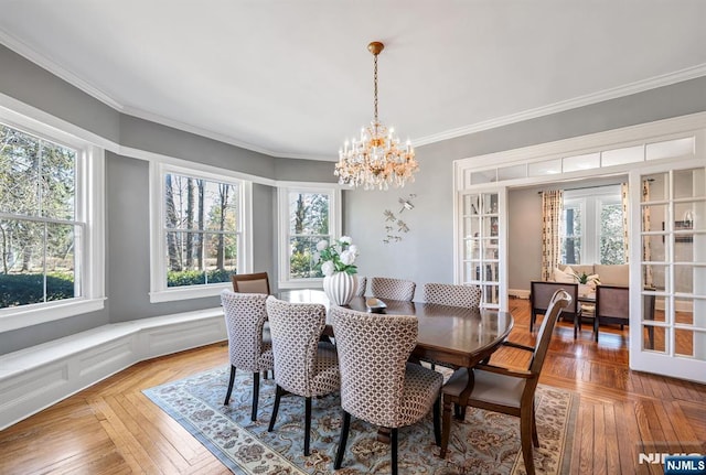 dining area featuring an inviting chandelier and crown molding