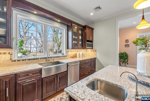 kitchen featuring a sink, visible vents, light stone counters, and dishwasher