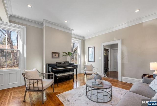 living area with crown molding, light wood-style flooring, recessed lighting, and baseboards