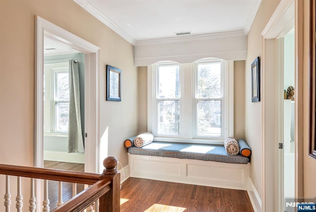 sitting room with baseboards, dark wood-style flooring, and crown molding