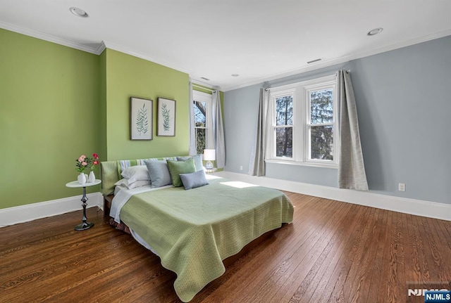 bedroom featuring crown molding, baseboards, and hardwood / wood-style floors