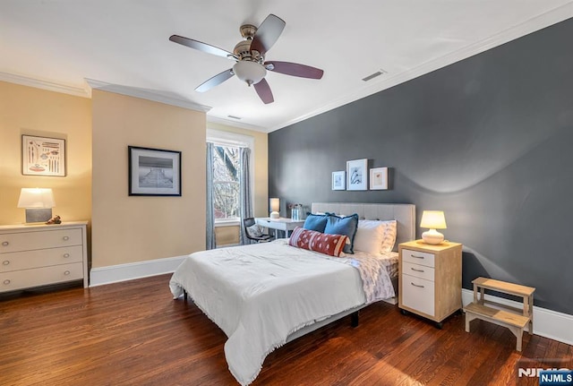 bedroom featuring visible vents, crown molding, and wood finished floors