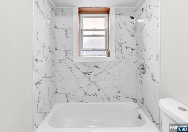 bathroom featuring tub / shower combination and toilet