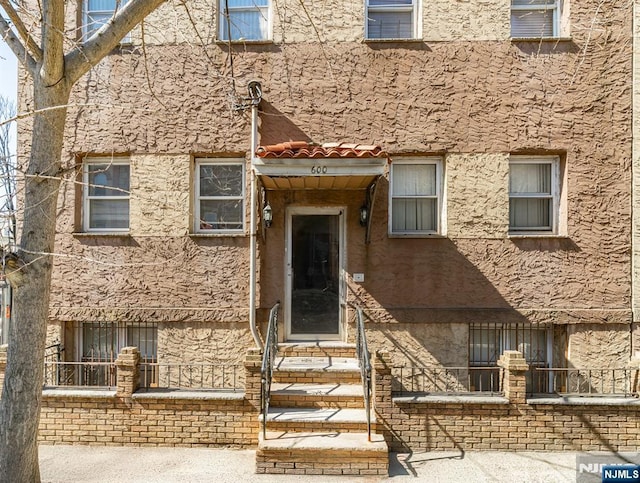 view of front of property featuring entry steps and stucco siding