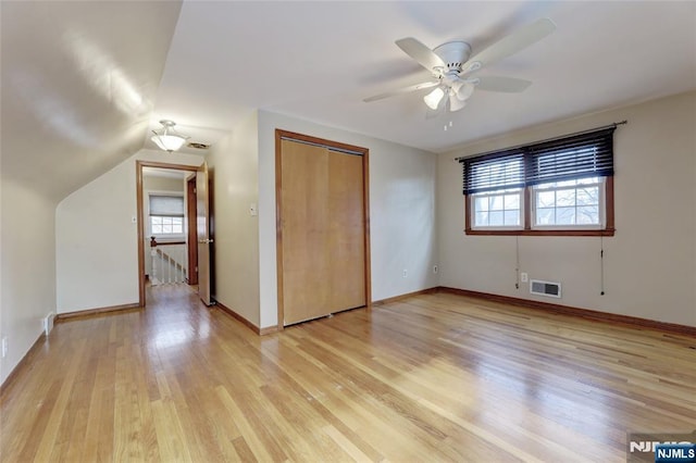 unfurnished bedroom featuring multiple windows, baseboards, visible vents, and light wood finished floors