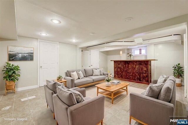 living area with recessed lighting and baseboards