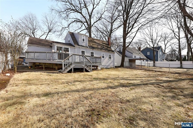 back of property featuring stairway, a wooden deck, a yard, and fence