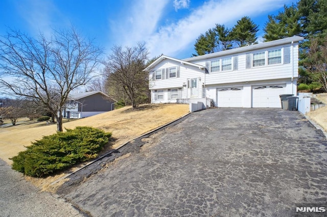 bi-level home with a garage and driveway