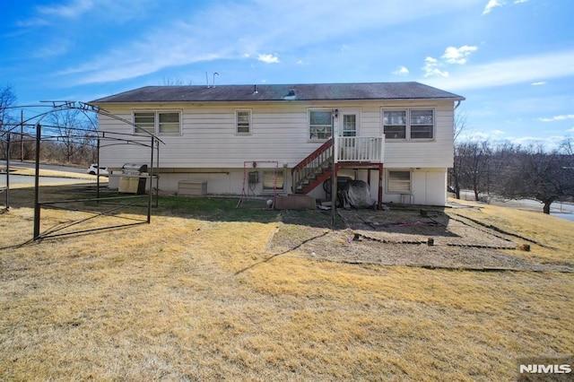 rear view of property with a lawn