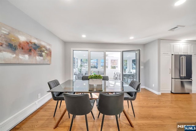 dining space with light wood-type flooring, a baseboard radiator, baseboards, and recessed lighting