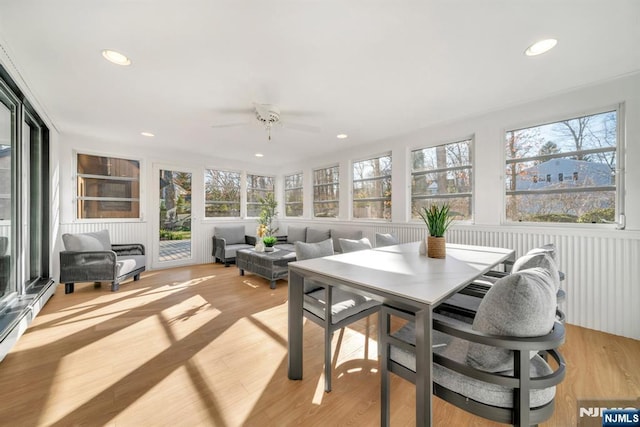 sunroom / solarium featuring plenty of natural light and ceiling fan