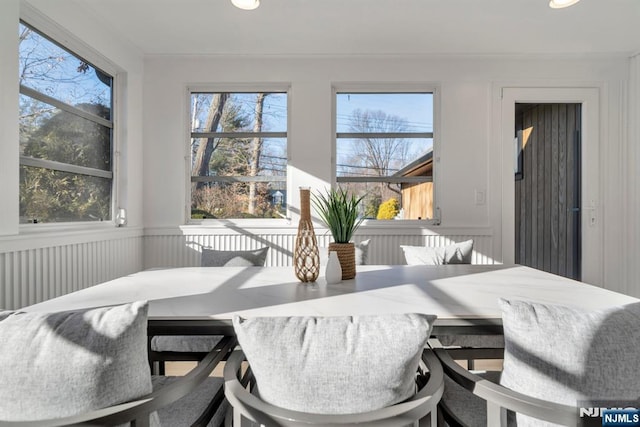 dining room with plenty of natural light and ornamental molding