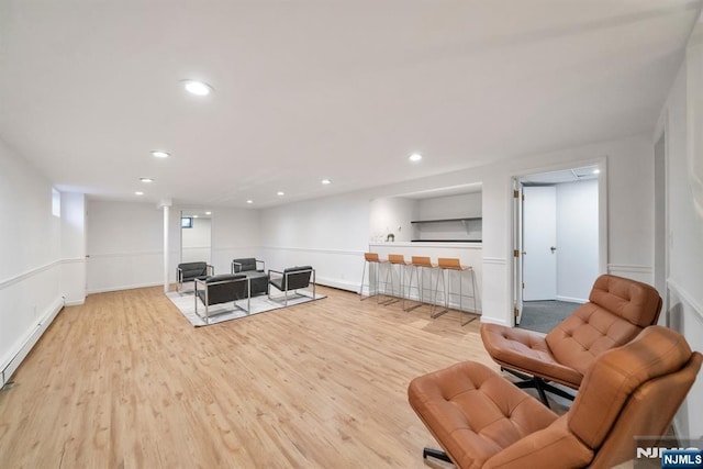 living area with recessed lighting, light wood-style floors, baseboards, and baseboard heating