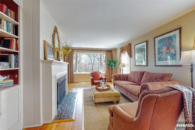 living room with a fireplace and wood finished floors