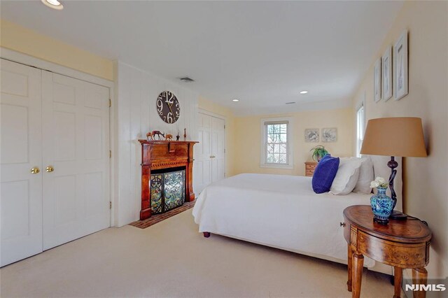 bedroom featuring recessed lighting, visible vents, a fireplace, and carpet flooring