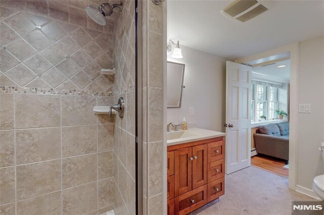 ensuite bathroom with visible vents, ensuite bath, a stall shower, and vanity