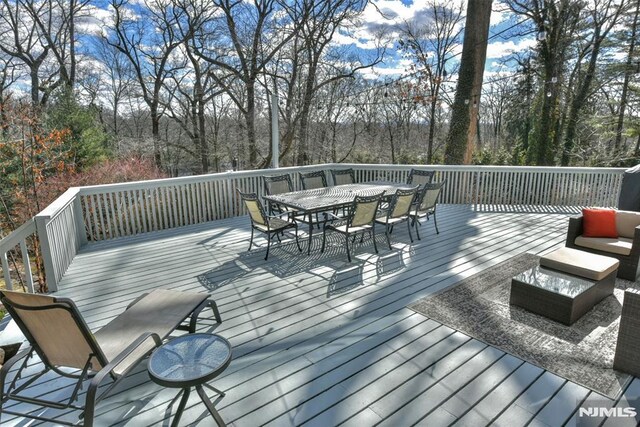 wooden terrace with outdoor dining area