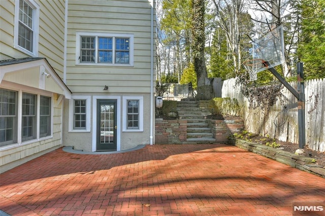 view of patio / terrace featuring stairs and fence