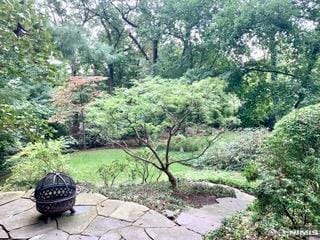 exterior space with a patio area and an outdoor fire pit