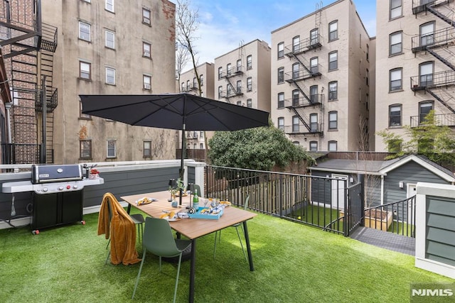 exterior space featuring a grill and fence