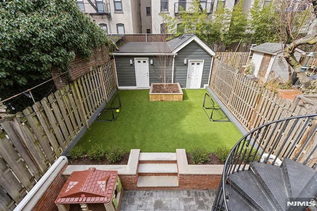 view of yard with an outbuilding and a fenced backyard