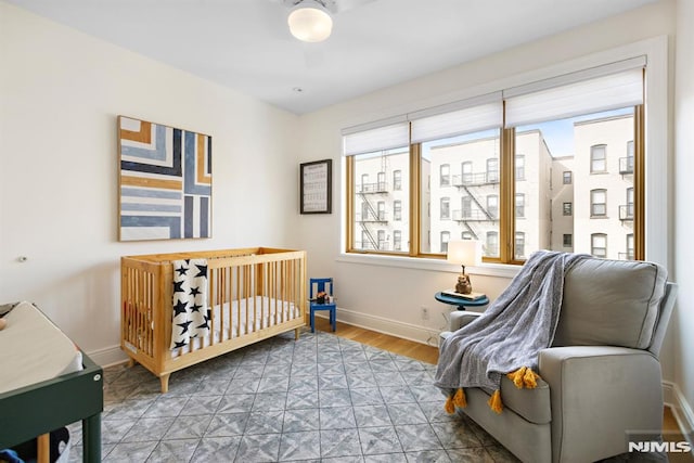 bedroom featuring wood finished floors and baseboards