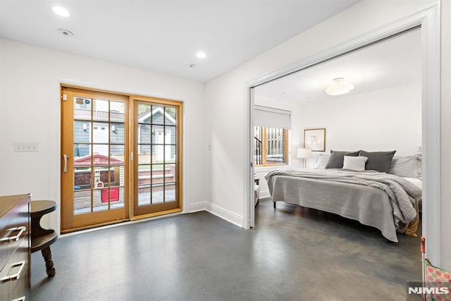 bedroom with recessed lighting, baseboards, concrete floors, and access to outside